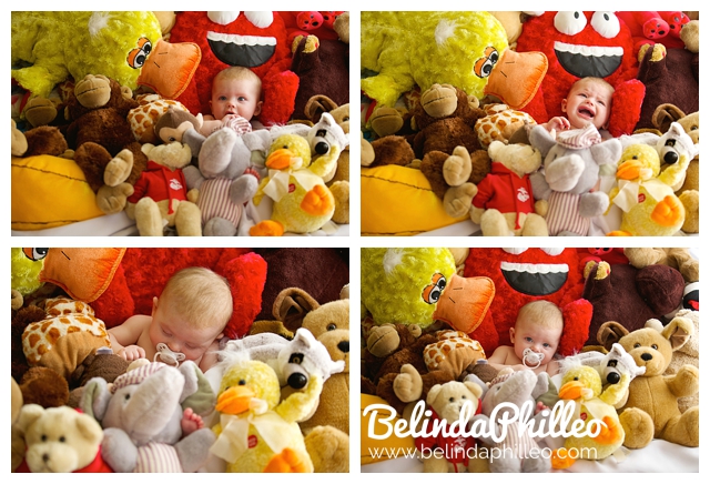 baby surrounded by stuffed animals