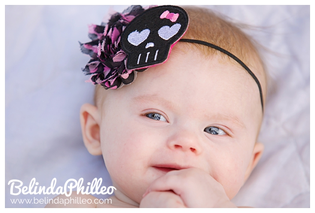 baby wearing skull headband
