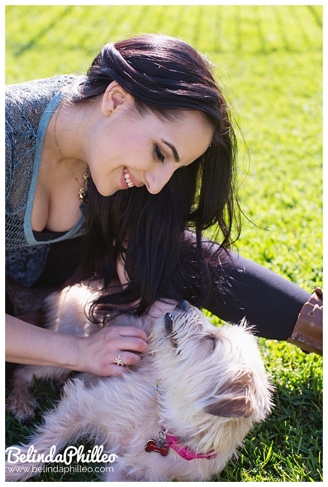 A woman and her wheaten terrier smiling