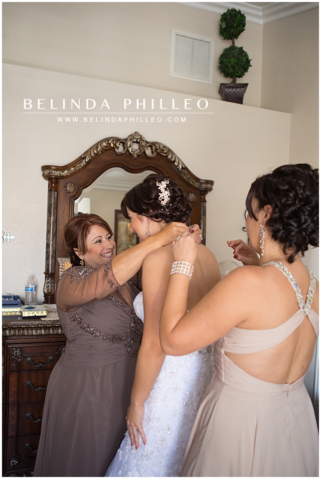 mother of the bride helping her daughter get ready