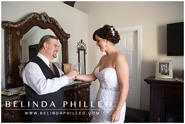 father of the bride putting on his daughter's bracelet