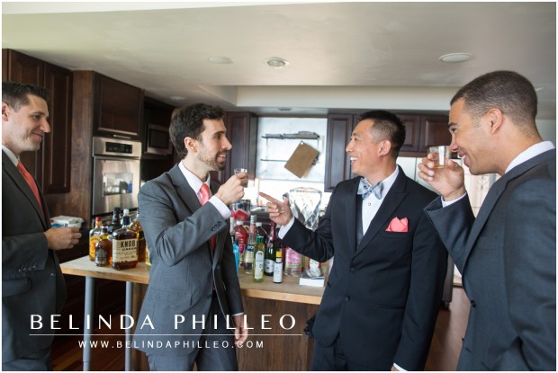 a groom and his groomsmen take shots of knob creek whiskey