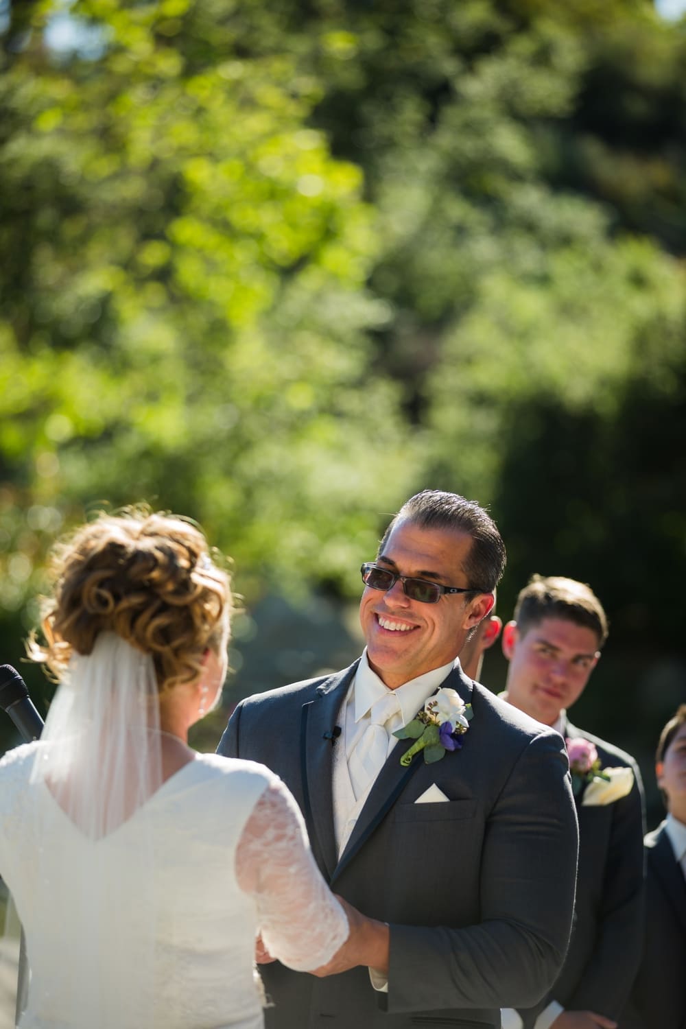 Groom smiles widely at his new bride during their Dove Canyon Golf Club wedding in Orange County, CA