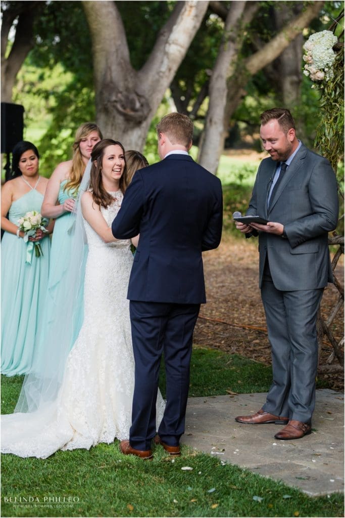 Bride and groom say their vows at Temecula Creek Inn. Photo by Belinda Philleo