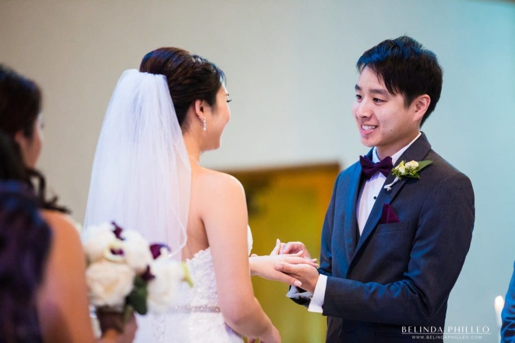 Bride and groom exchange rings at the San Gabriel Mission and church