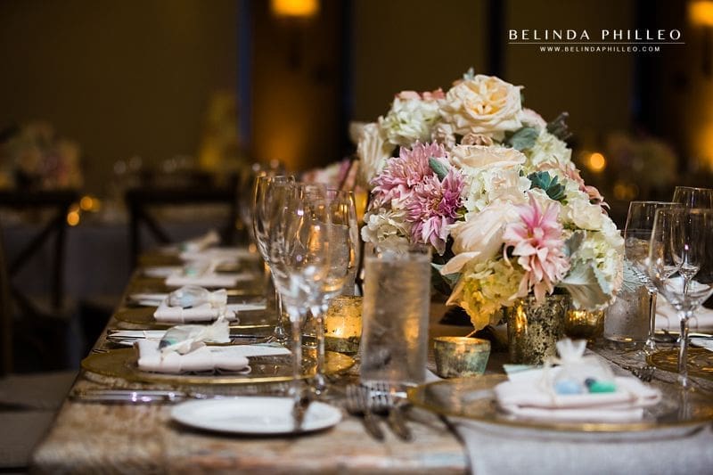 White and pink flowers adorn rustic tables for wedding reception at The Ranch Laguna