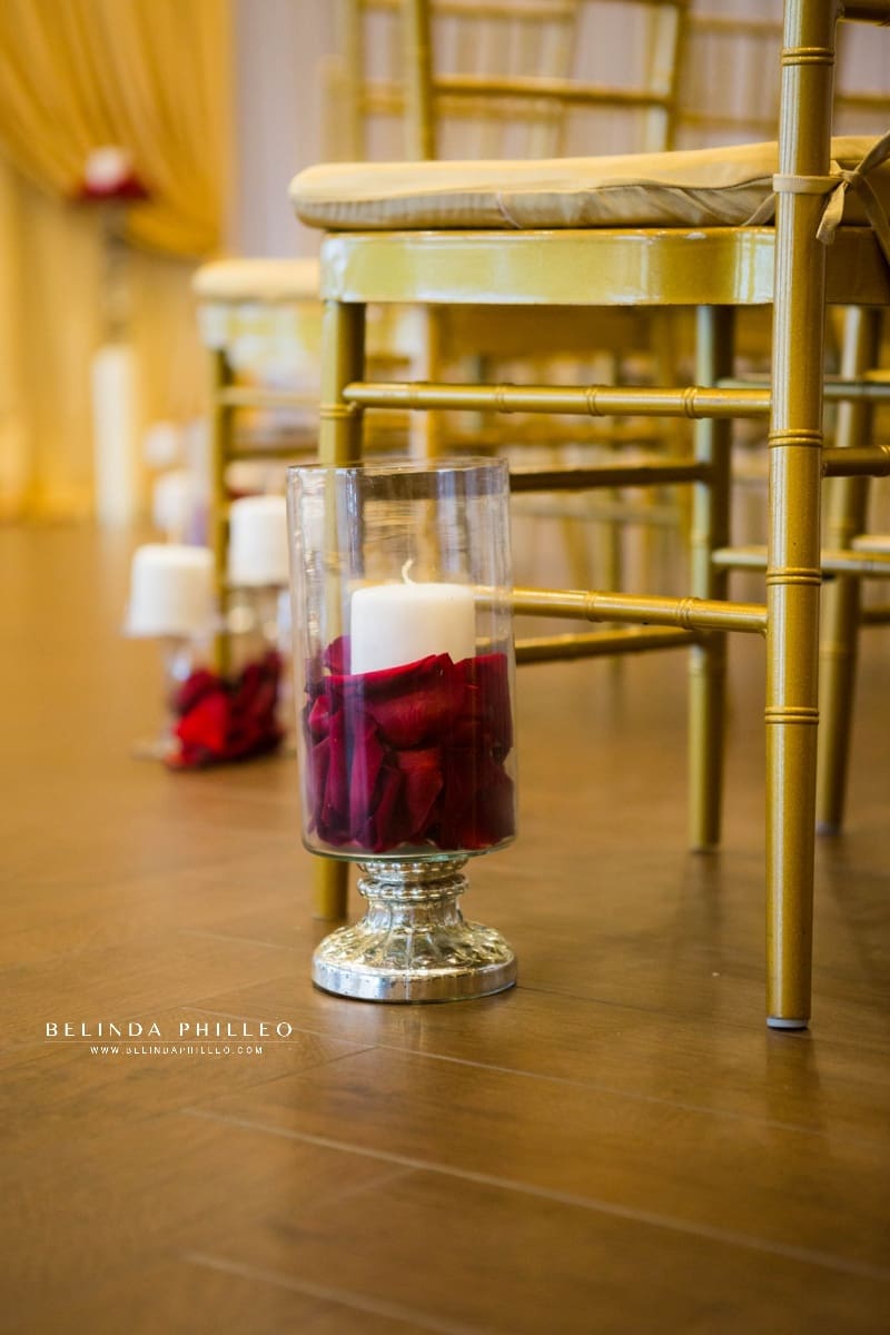 Red roses and candles line the aisle of wedding ceremony at The Hills Hotel Laguna