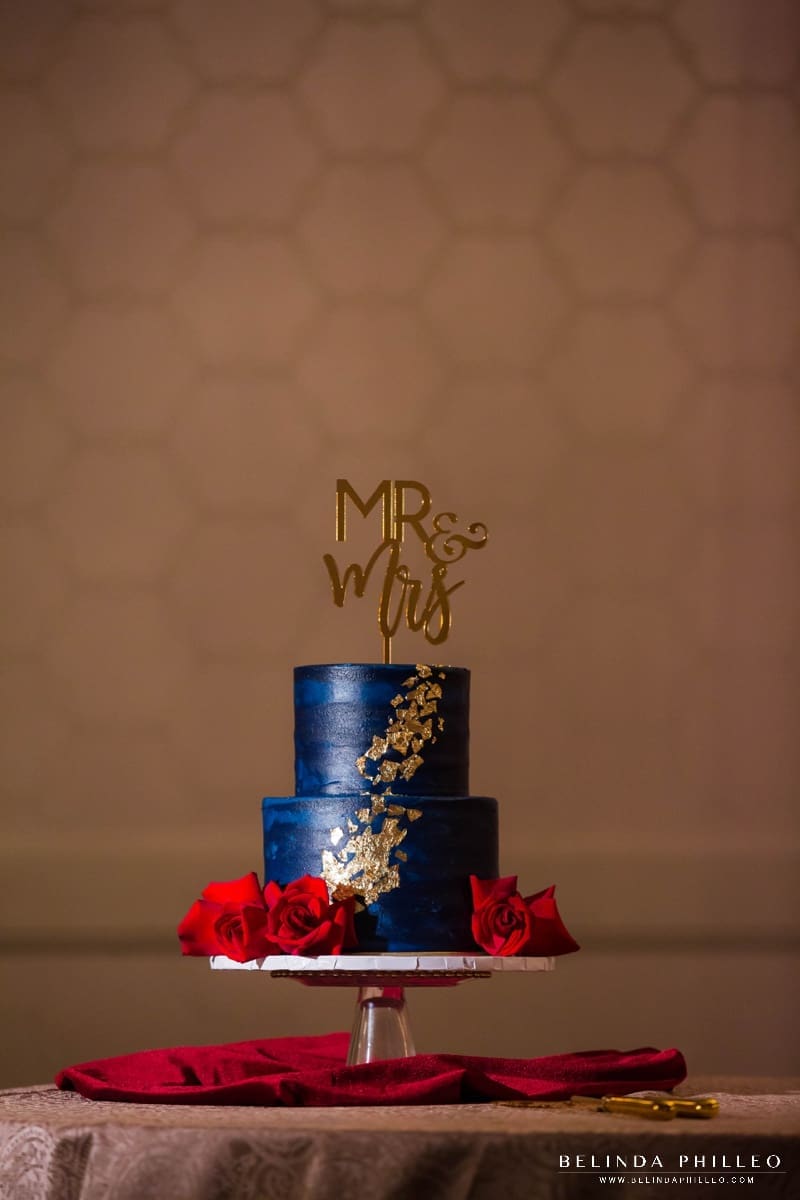Navy blue and gold wedding cake with gold acrylic Mr & Mrs cake topper sign