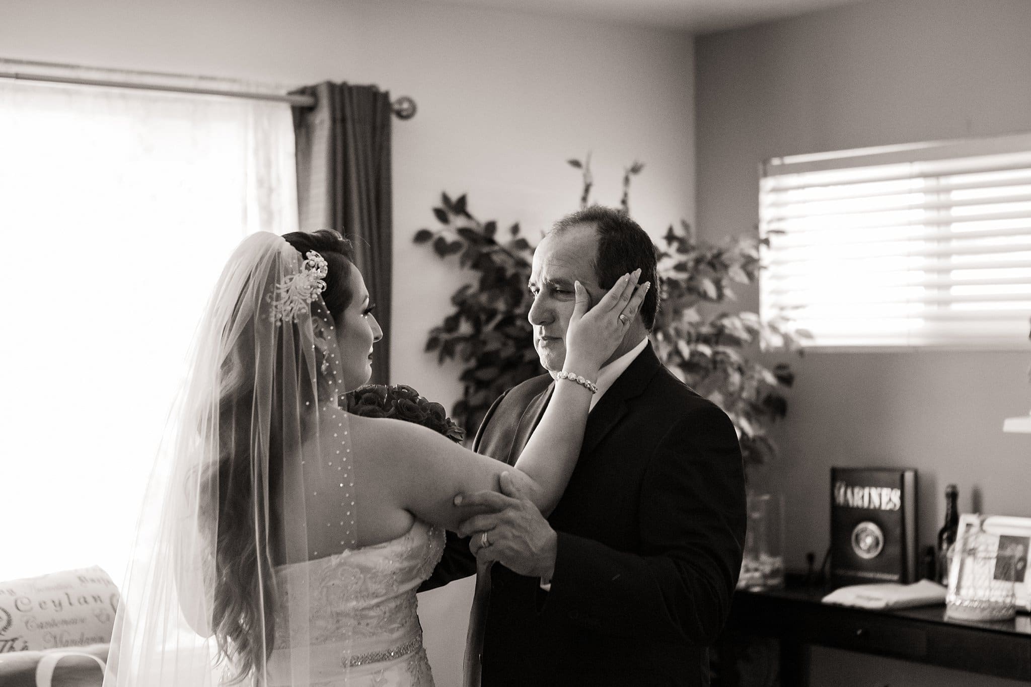 Father of the bride cries when he sees her for the first time as a bride.