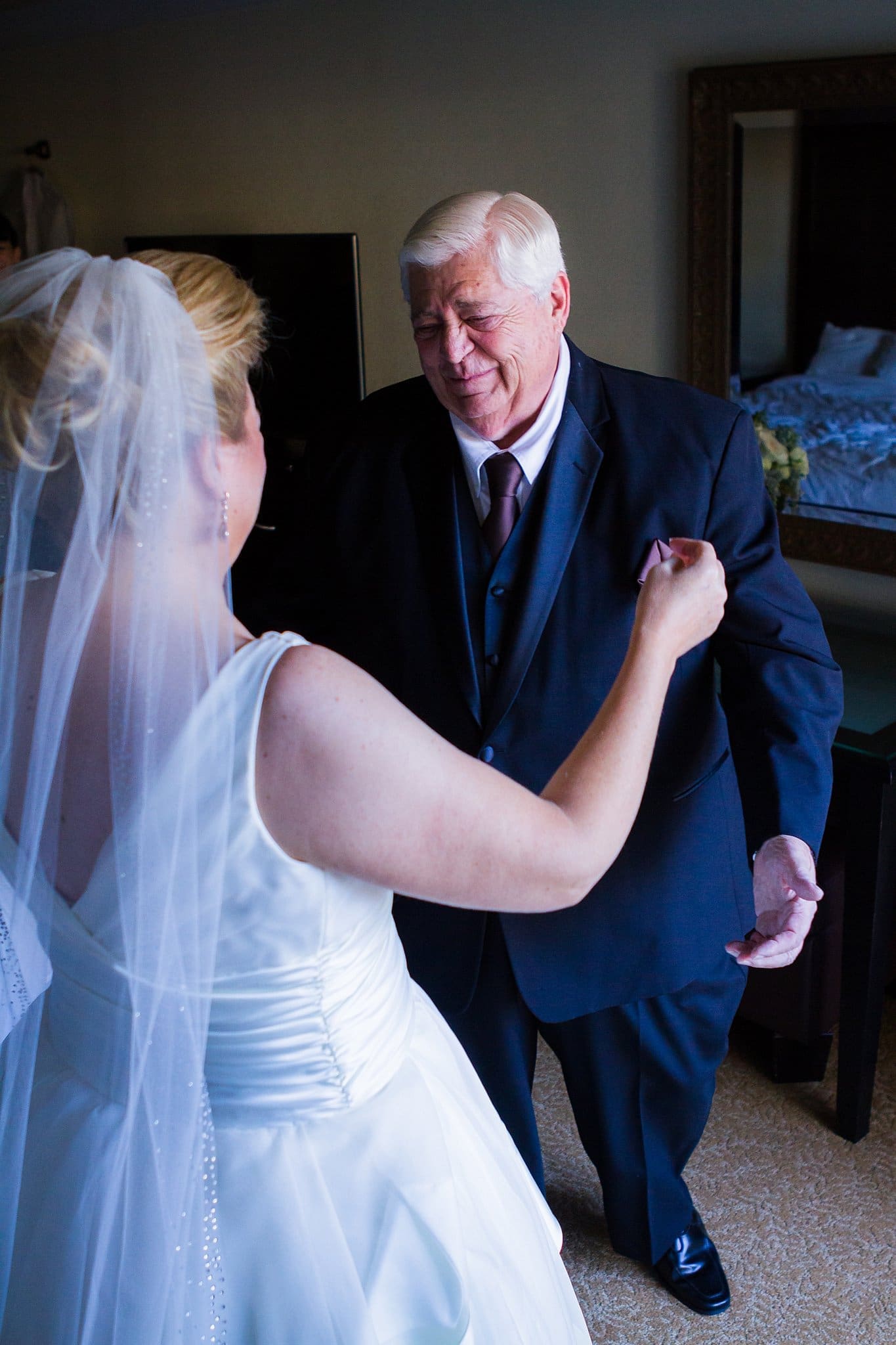Emotional wedding photos. Bride does a first look with her elderly father and he starts to cry.
