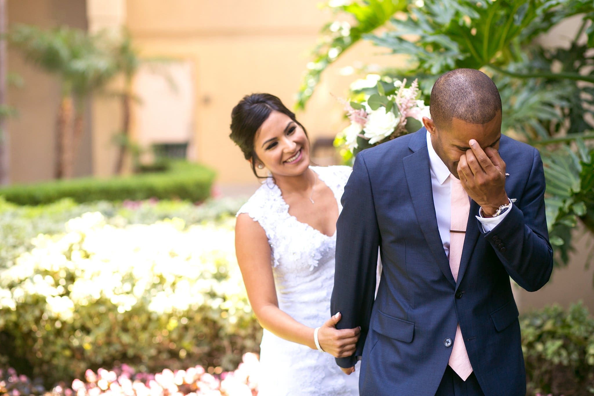 Emotional wedding photos: The groom turns away and cries during the first look with his beautiful bride.