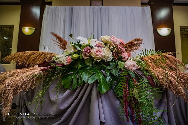 Tropical sweetheart table florals by Serenade of Flowers in Orange County, CA. Photo by Belinda Philleo