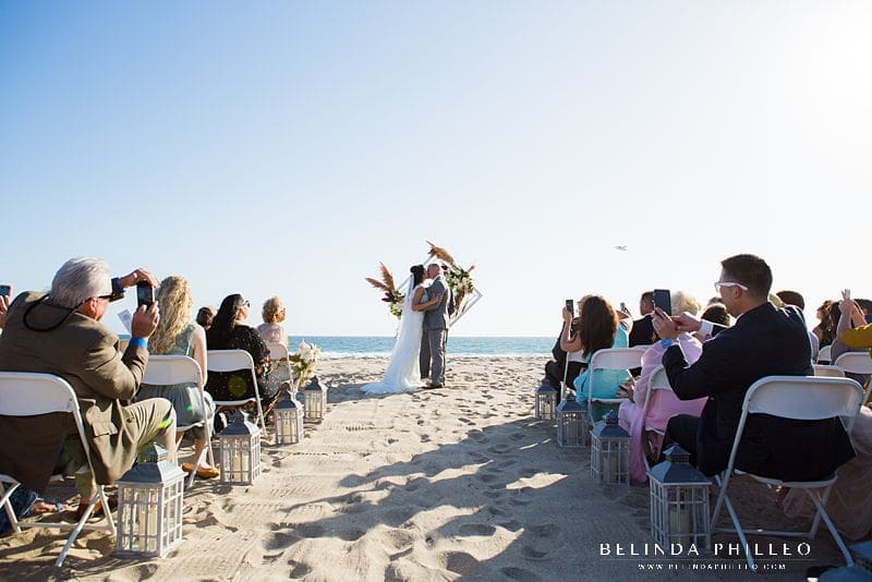 Bride and groom share first kiss at their intimate Huntington Beach wedding