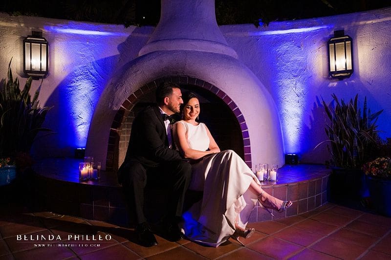 bride and groom snuggle in front of fireplace at Los Angeles River Center & Gardens wedding