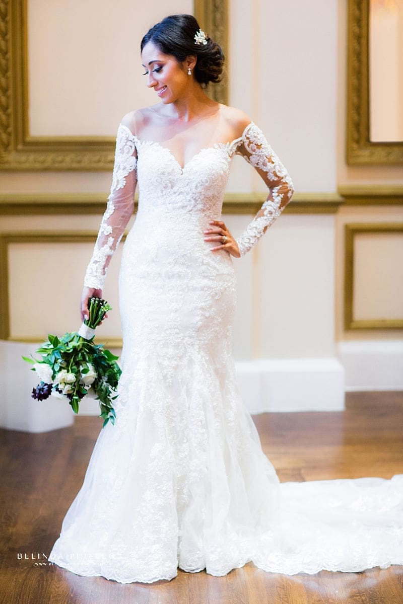 Bride shows off her Martina Liana bridal gown at during her Los Angeles wedding at Alexandria Ballrooms. Photographed by Belinda Philleo