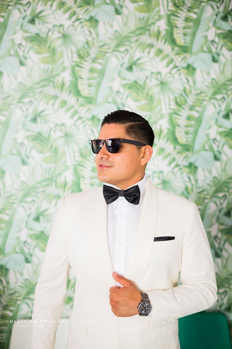Custom white tux and black bowtie for groom at his Los Angeles Wedding. Photography by Belinda Philleo