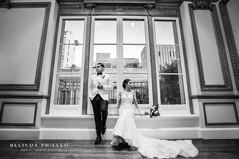 Newly weds pose for a photograph during their wedding at Alexandria Ballrooms in Los Angeles, CA. Photo by Belinda Philleo
