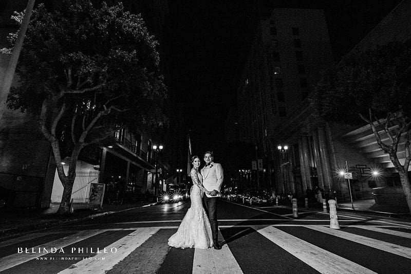 Bride and groom pose for night photos during their wedding at Alexandria Ballrooms in Downtown Los Angeles. Photo by Belinda Philleo