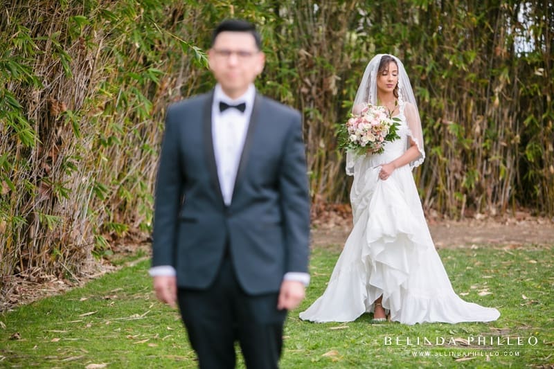 Bride wearing Justin Alexander dress about to have first look with her groom