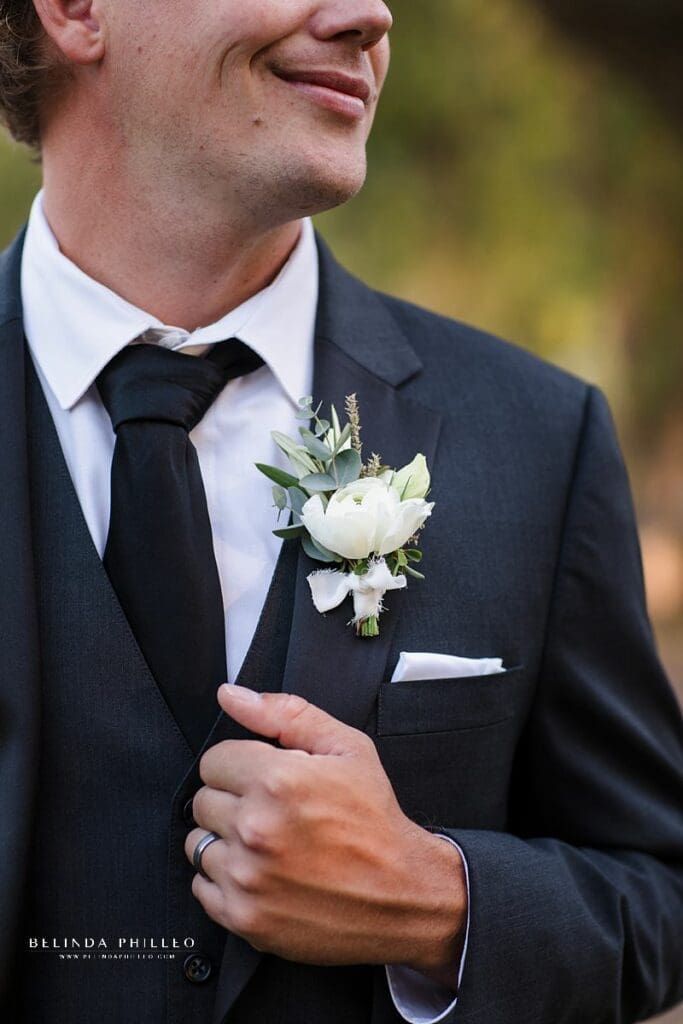 White ranunculus groom boutonnière by Third and Park florist