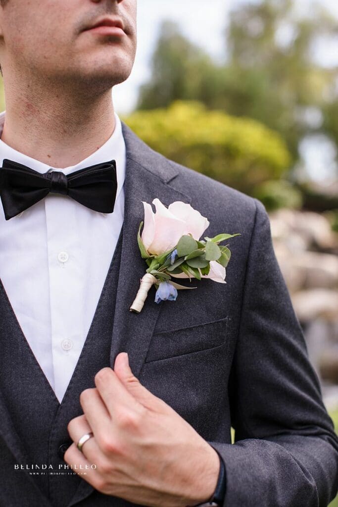 Grey groom tux with blush and blue boutonniere
