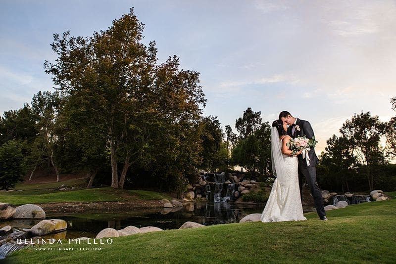 Bride and groom pictures at waterfall during Coyote Hills Golf Course wedding in Fullerton, CA