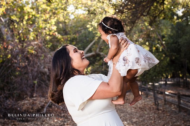 Candid portrait of mom and her baby. Irvine Regional Park family portraits by Belinda Philleo