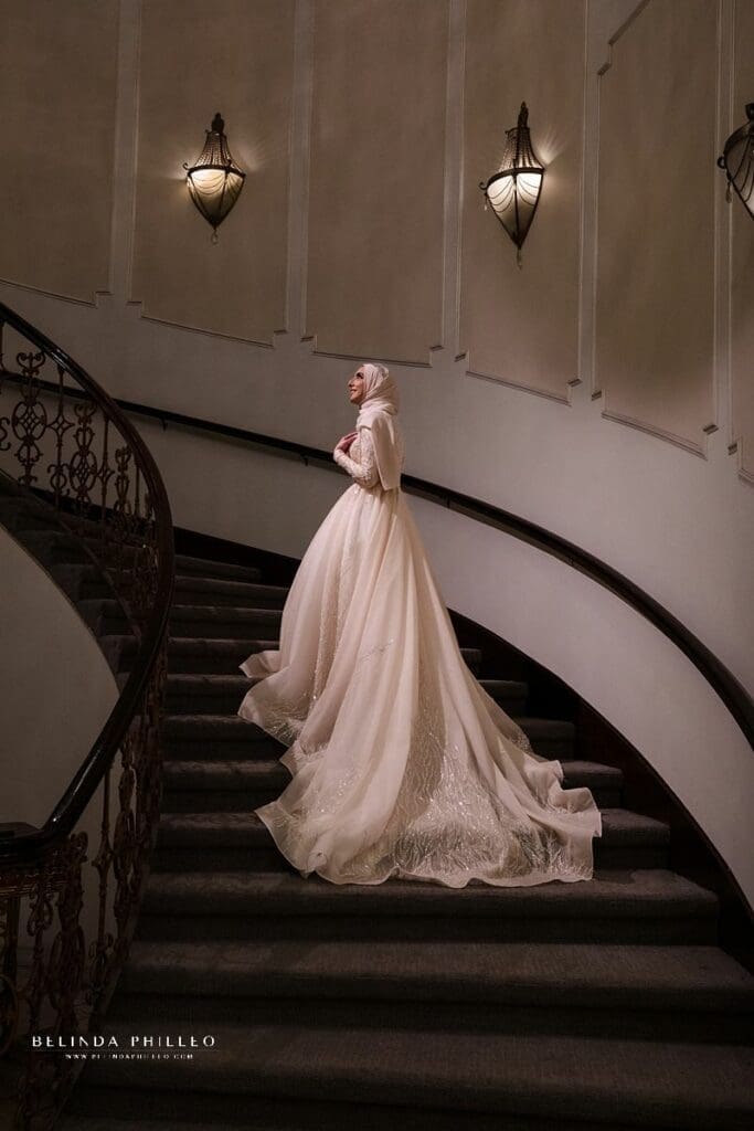Bride awaits her groom on grand staircase at The Brandview Ballroom wedding venue in Glendale, CA. Photo by Belinda Philleo, a Certified Professional Photographer in Orange County, CA.