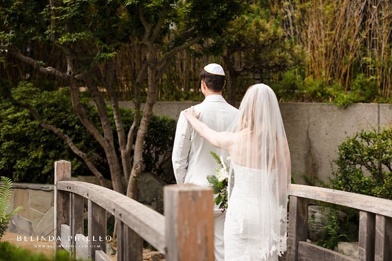 Bride and groom share their first look on the garden bridge at JACCC in Los Angeles, Ca
