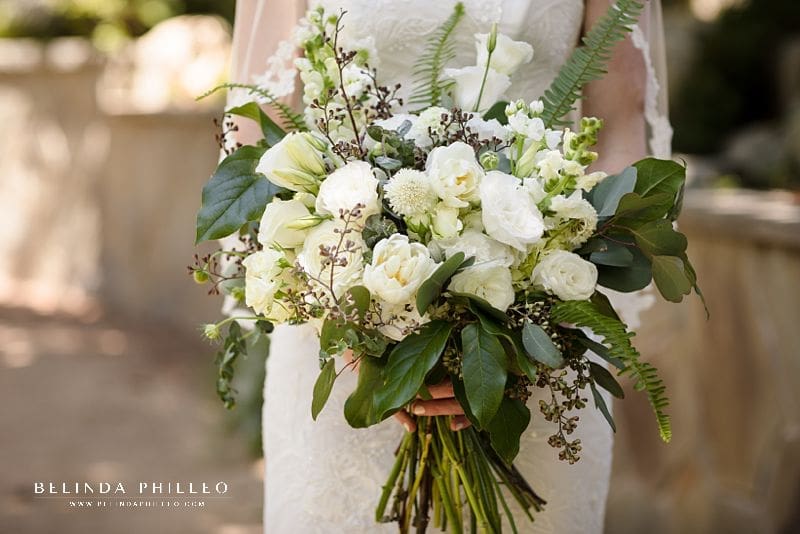 All white bridal bouquet with lush green and fern accents