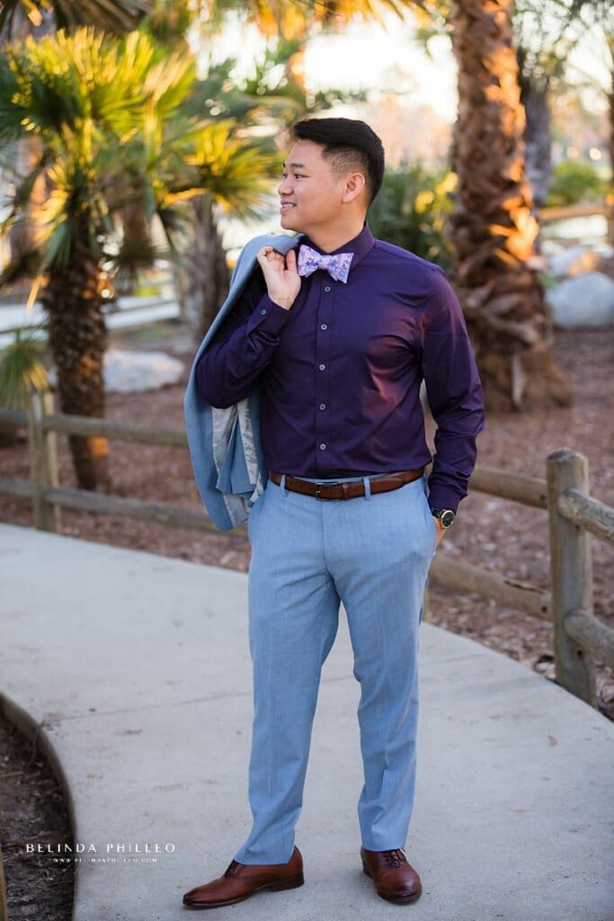 A groom stands with his hand in his pocket awaiting his new bride. Orange County wedding photographer shares her best posing tips for men in photographs.