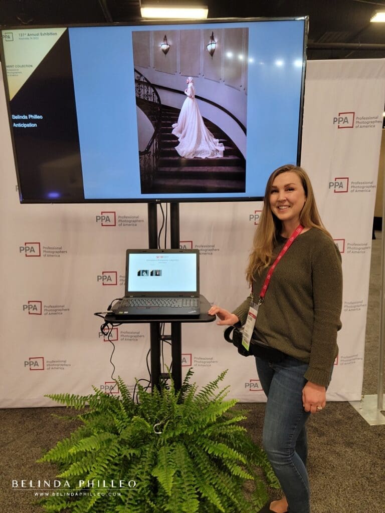 Photographer Belinda Philleo stands beside her Merit image "Anticipation" at the International Photographic Competition Exhibit Imaging USA in Nashville, TN. 2023