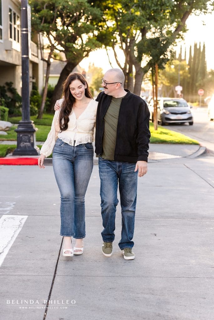Couple walking around during their engagement session in historic Old Towne Orange district