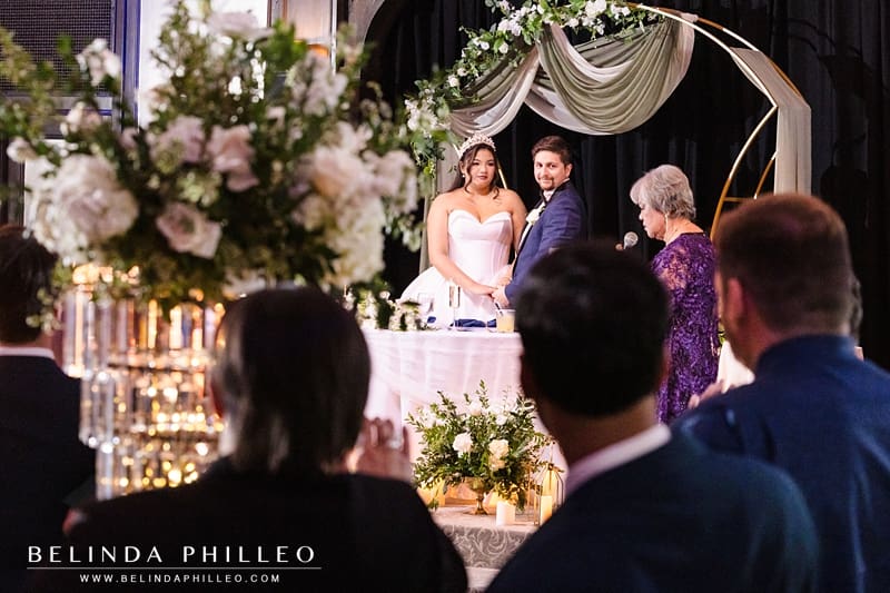 Bride's grandmother makes a speech as wedding guests look on