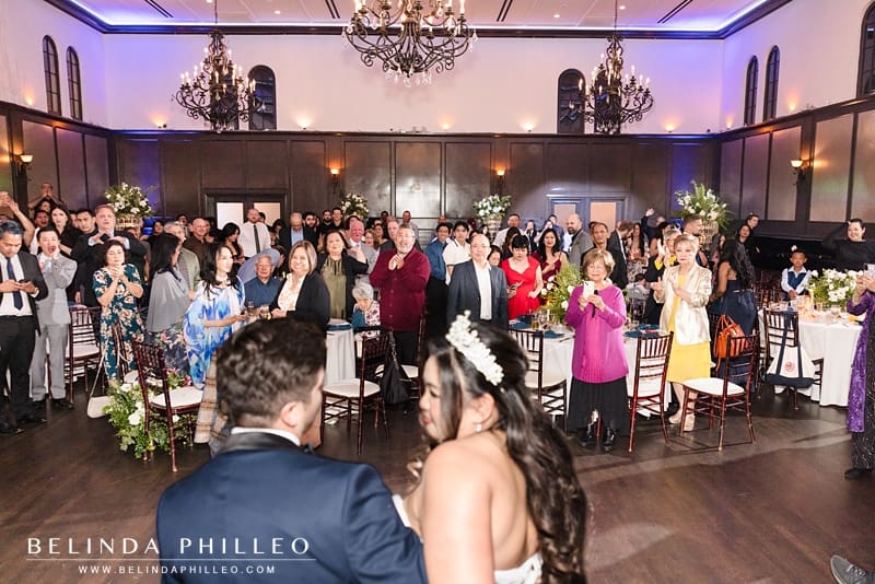 Guests cheer as the newlyweds make their grand entrance